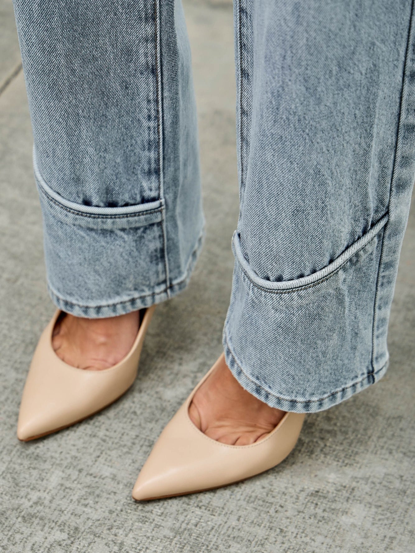 Mid Rise Straight With Piping styled with beige pointed-toe heels, showcasing denim details and a sophisticated look.