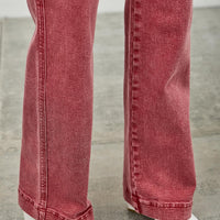 High Rise Slim Wide Straight jeans in red with white ankle boots on a gray floor.