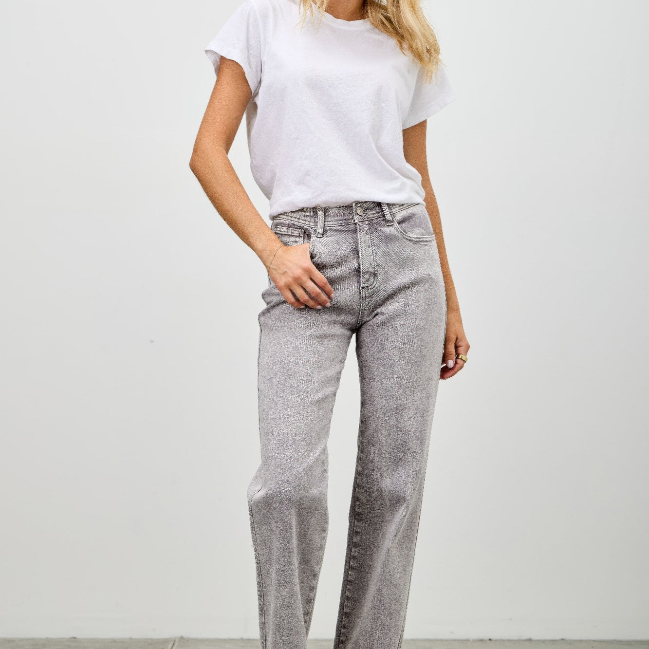 Model wearing High Rise Slim Wide Straight jeans paired with a white t-shirt in a casual setting.