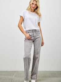 Model wearing High Rise Slim Wide Straight jeans paired with a white t-shirt in a casual setting.