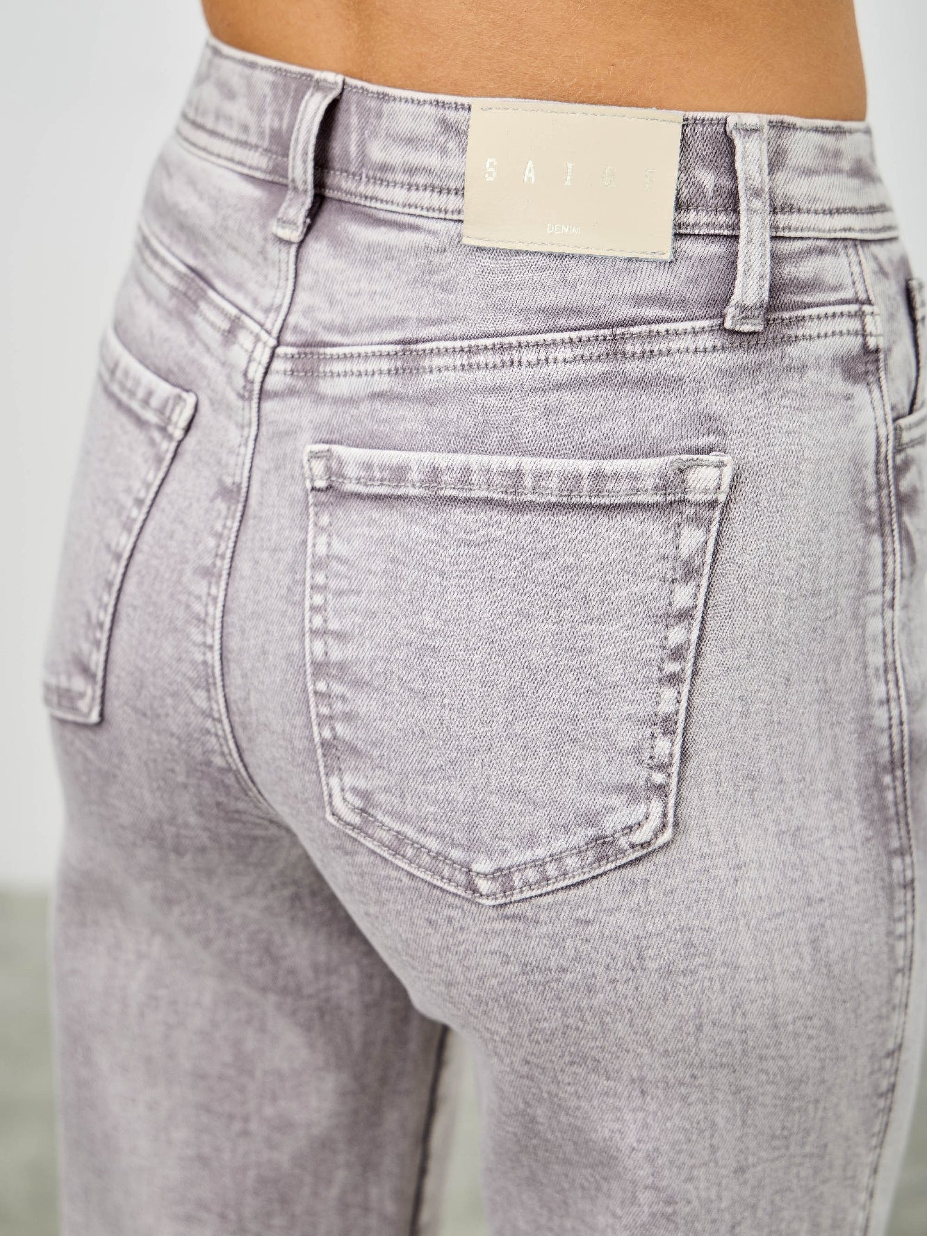 High Rise Slim Wide Straight jeans showcasing a modern high-rise waist and sleek back pocket design.