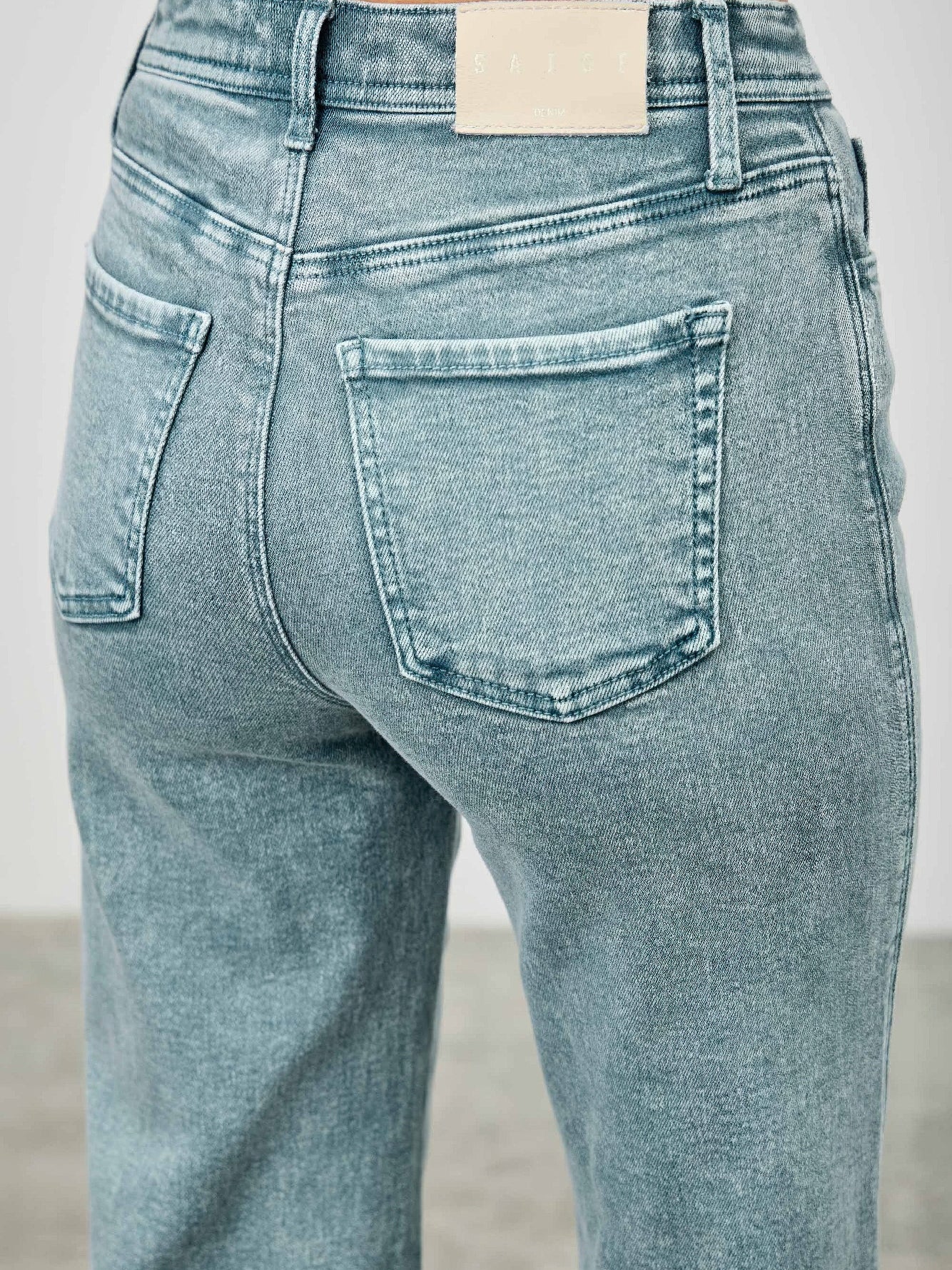Back view of High Rise Slim Wide Straight jeans showcasing their flattering fit and modern design.