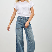 Model wearing High Rise Double Pocket Wide Leg jeans with a white t-shirt and relaxed stance.