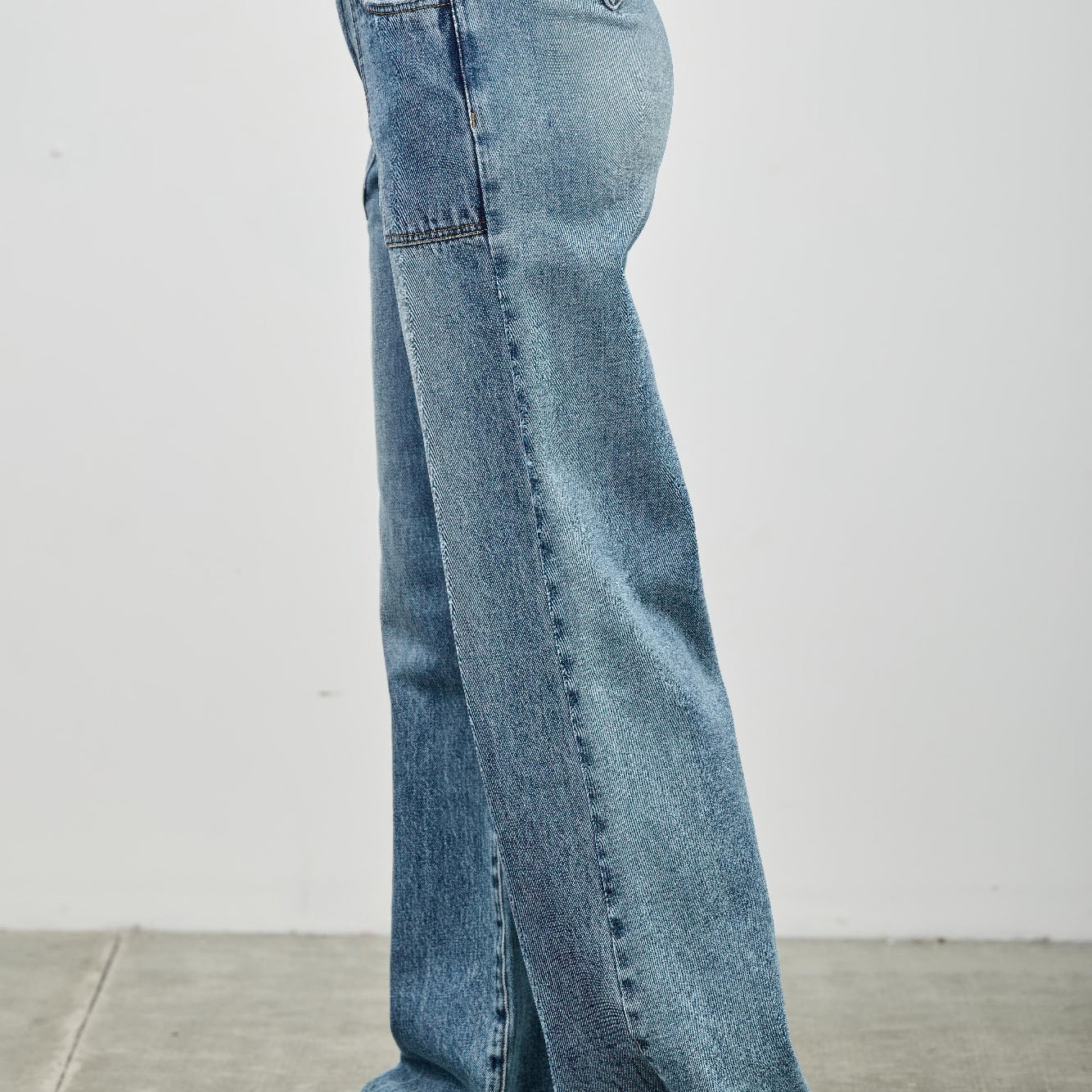 High Rise Double Pocket Wide Leg jeans in light wash with a relaxed fit and a wide leg silhouette, shown from the side.