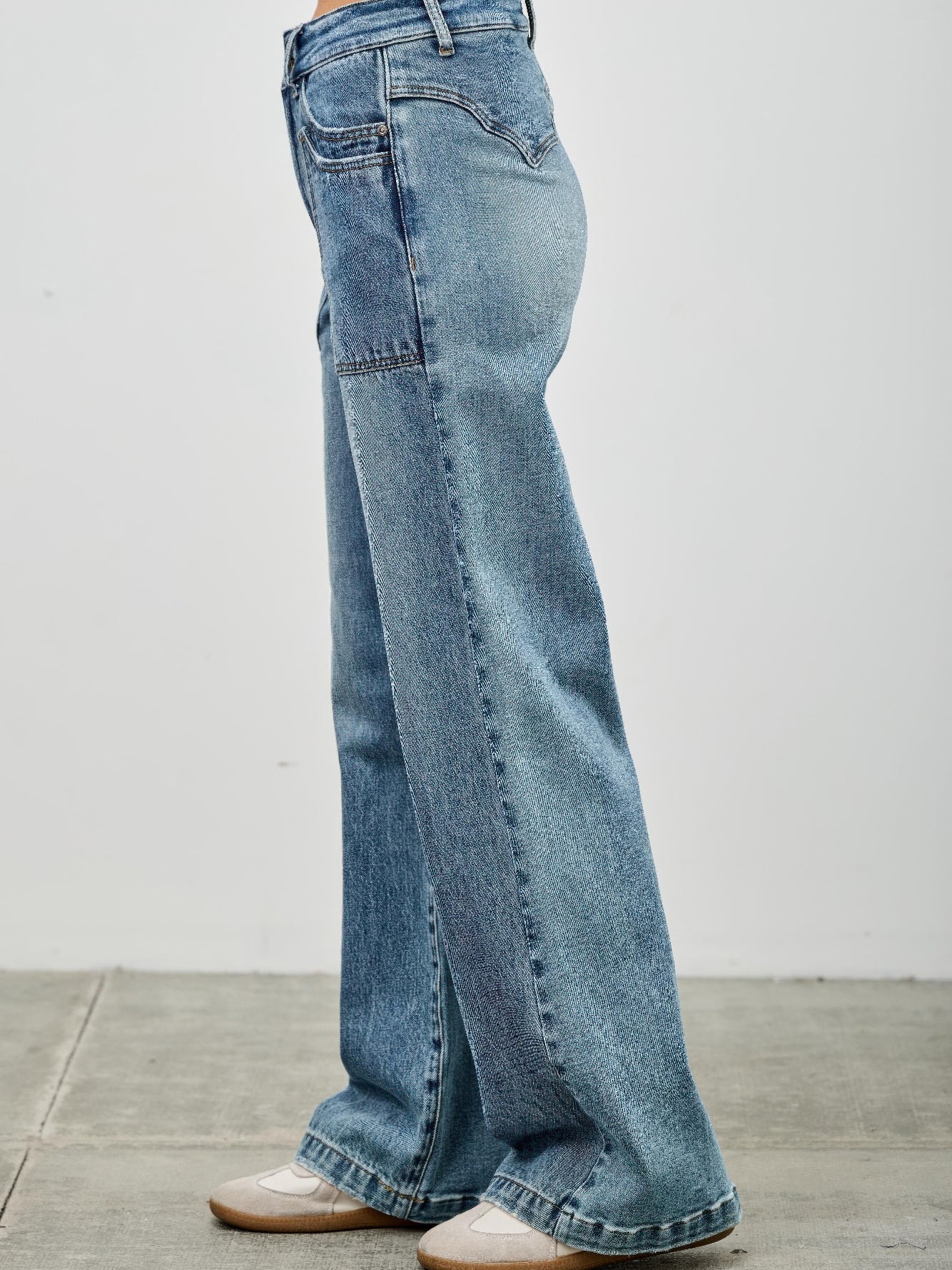 High Rise Double Pocket Wide Leg jeans in light wash with a relaxed fit and a wide leg silhouette, shown from the side.