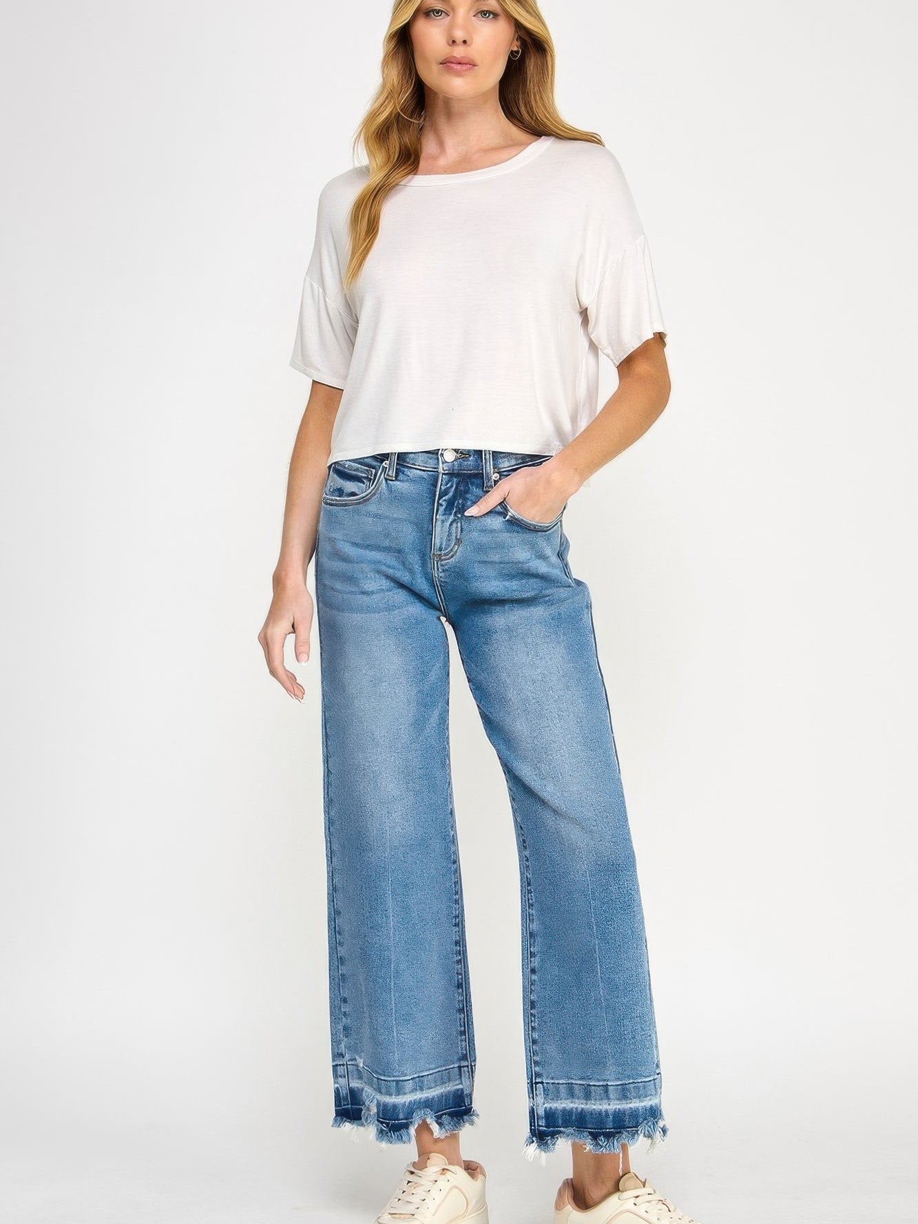 Model showcasing Tummy Control High Rise Crop Wide W/ Released Hem jeans with a relaxed fit and released hem.