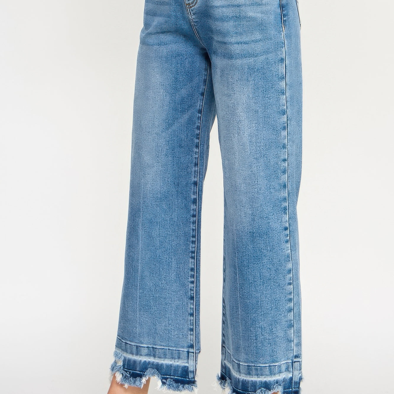 Tummy Control High Rise Crop Wide W/ Released Hem in light blue wash with frayed hem and relaxed fit.