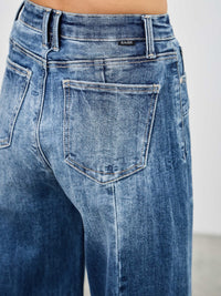 Mid Rise Wid Leg jeans showcasing a stylish back view with a classic wash and relaxed fit.