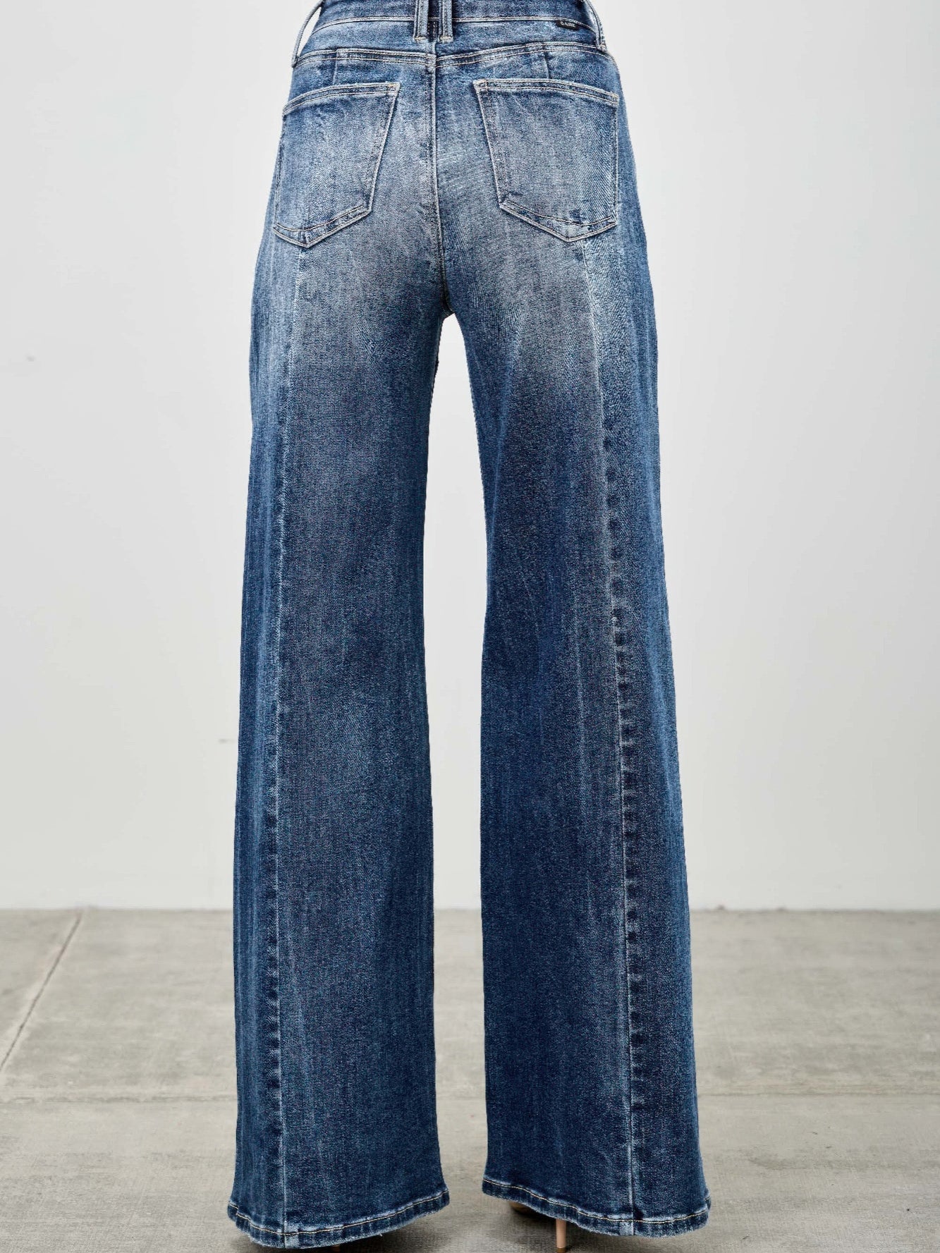 Back view of mid rise wide leg jeans showcasing the relaxed fit and stylish denim blend.