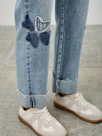 High Rise Star & Heart Patched Dad Jean W/stretch featuring playful heart and star patches on a light blue denim.