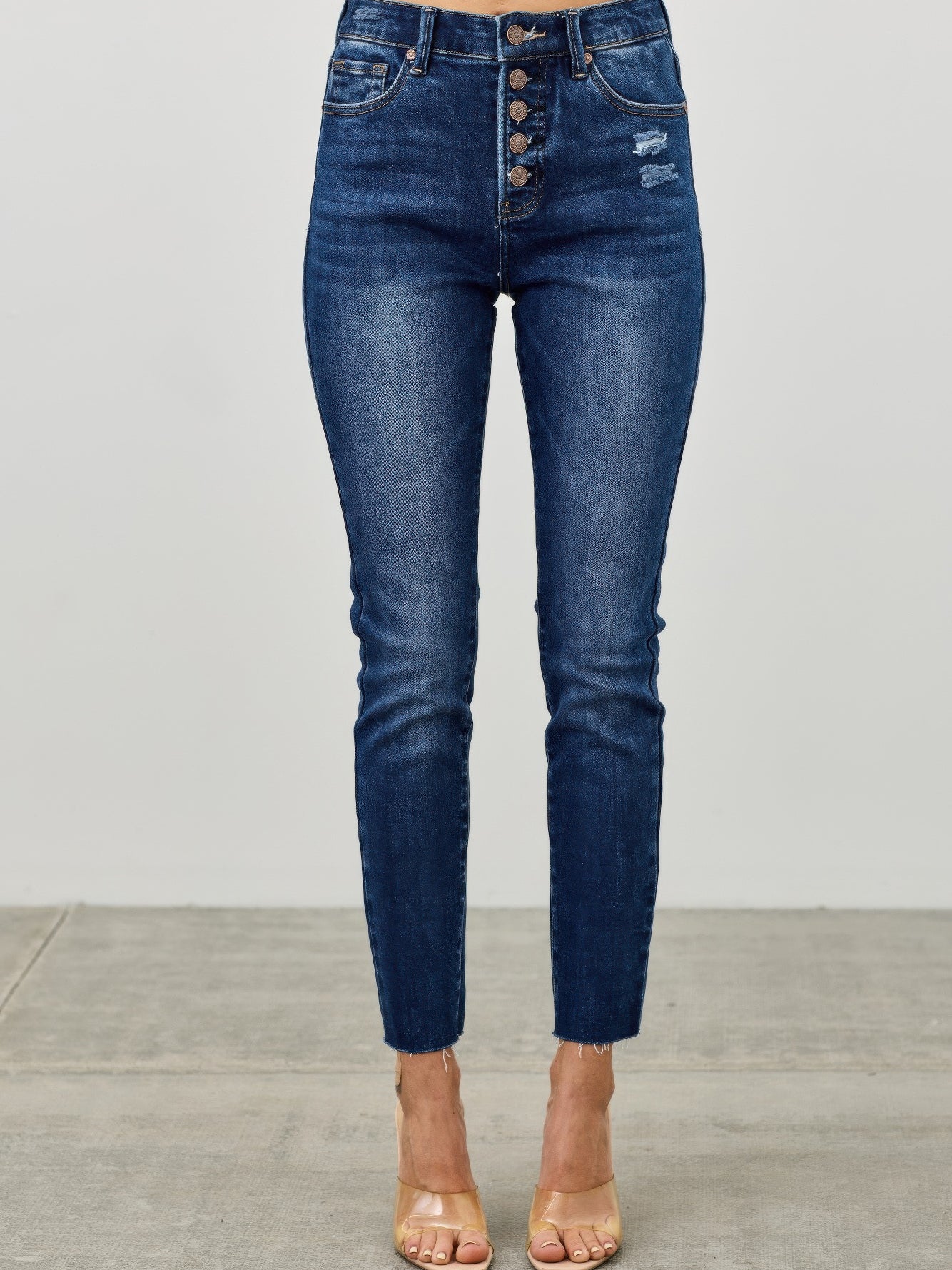 High Rise Ankle Skinny With Button Fly showcasing a stylish and fitted design with exposed button fly.