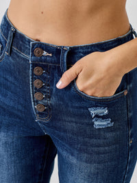 High Rise Ankle Skinny With Button Fly featuring a stylish exposed button fly and distressed detailing.
