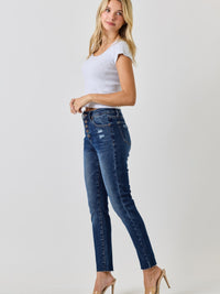 Model wearing High Rise Ankle Skinny With Button Fly jeans with a casual white top.