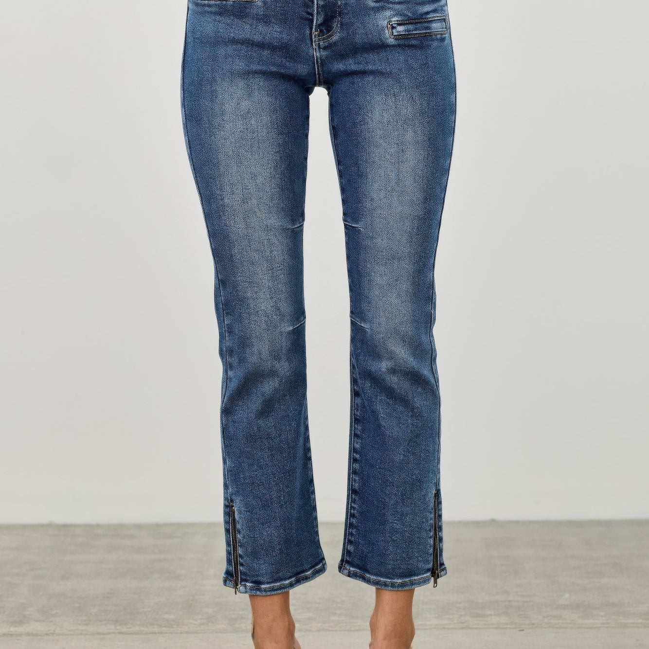Mid Rise Skinny Crop Tummy Control jeans featuring a flattering fit and cropped length for a stylish look.