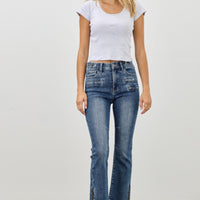 Model wearing Mid Rise Skinny Crop Tummy Control jeans, showcasing a flattering fit and cropped length.