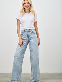 High Rise Wide Leg jeans styled with a white t-shirt for a trendy, casual look.