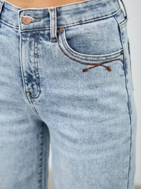 Close-up of high rise wide leg jeans highlighting the flattering fit and classic five-pocket styling.