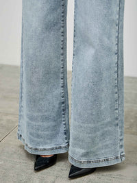 High Rise Wide Leg jeans featuring a wide leg cut and high-rise waist, paired with stylish black pointed heels.