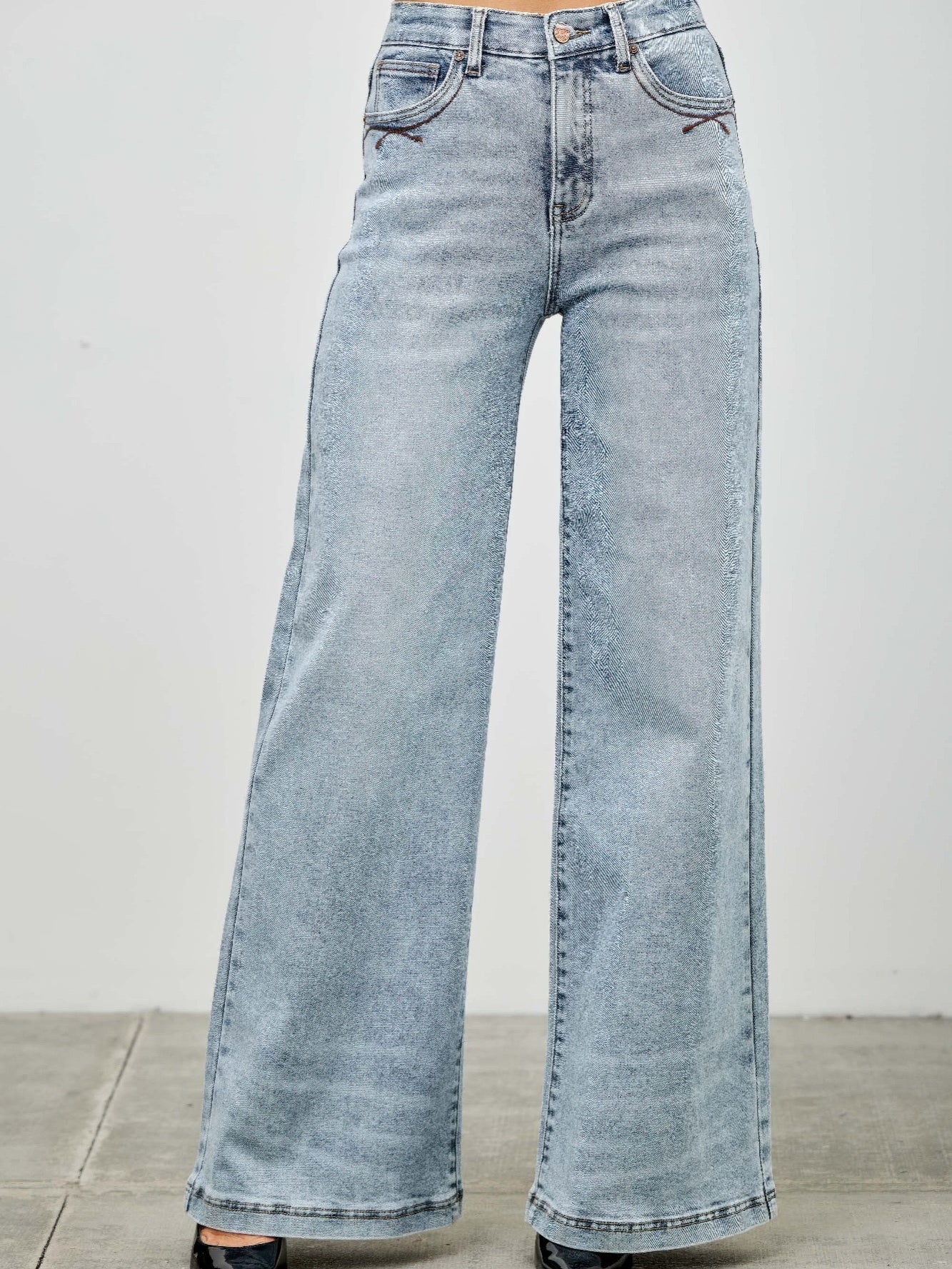 High Rise Wide Leg denim jeans in light wash with wide legs and five-pocket styling, perfect for casual and stylish outfits.