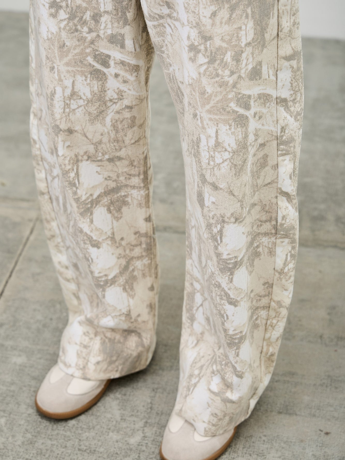 High Rise Low Curve Barrel jeans featuring a unique printed design and contemporary silhouette.