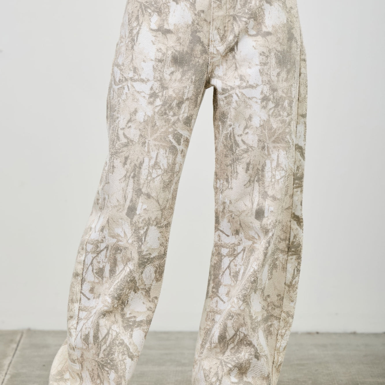 High Rise Low Curve Barrel jeans with a unique printed design and contemporary silhouette, showcasing a flattering fit.