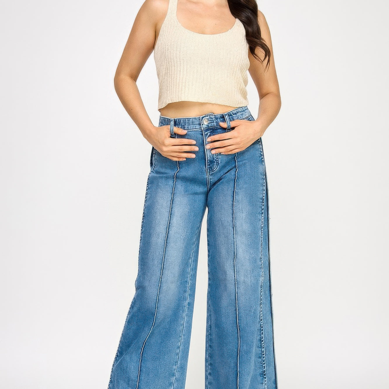 Model wearing High Rise Wide Leg With Tummy Control jeans and a ribbed crop top, showcasing a stylish outfit.