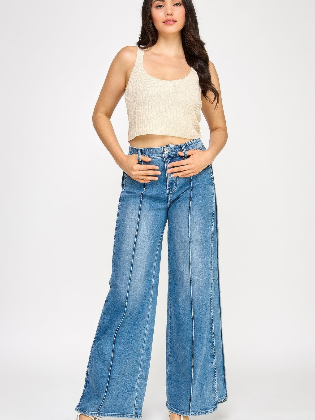 Model wearing High Rise Wide Leg With Tummy Control jeans and a ribbed crop top, showcasing a stylish outfit.