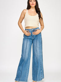 Model wearing High Rise Wide Leg With Tummy Control jeans and a ribbed crop top, showcasing a stylish outfit.