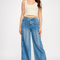 Model wearing High Rise Wide Leg With Tummy Control jeans, showcasing a flattering fit and stylish design.