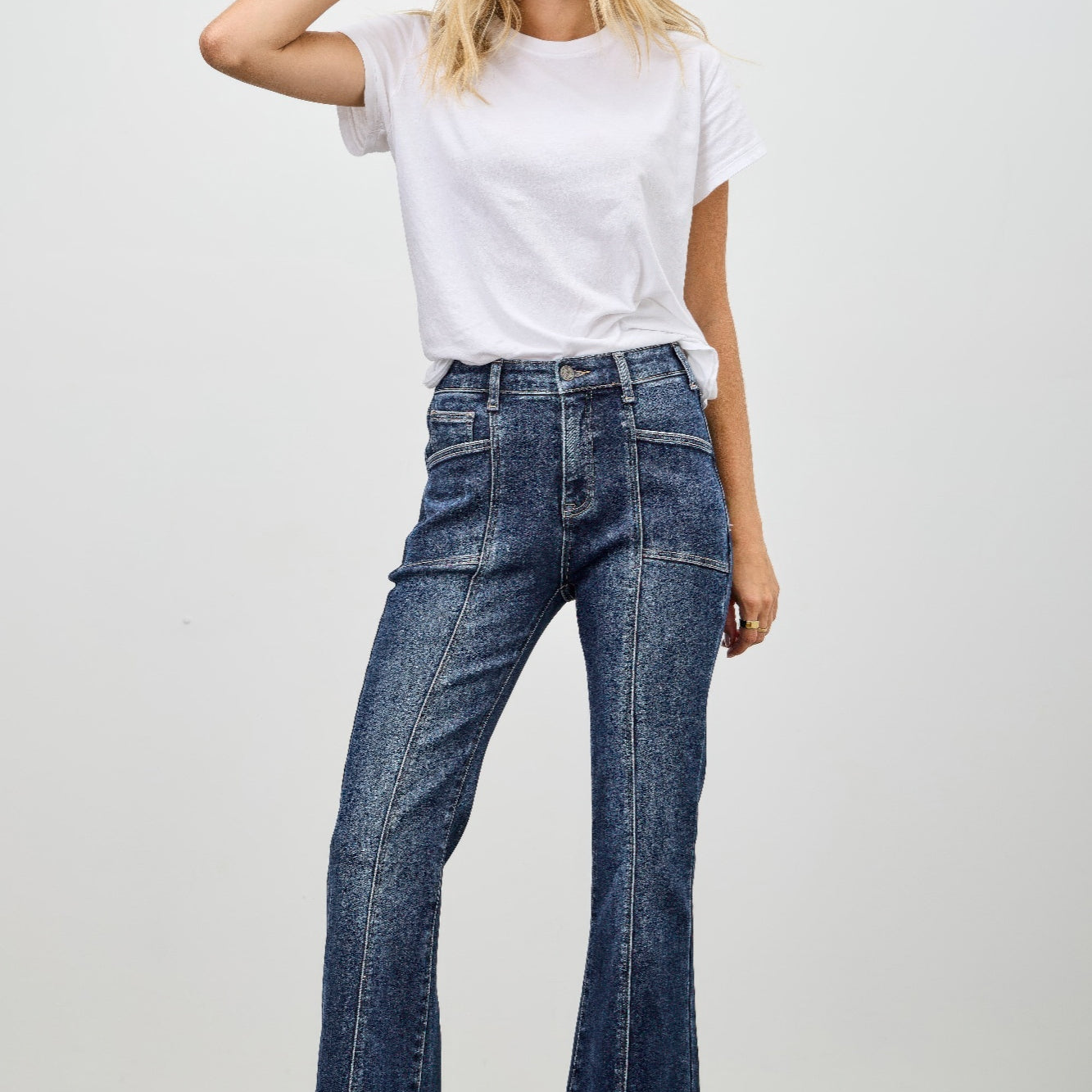 Model wearing High Rise Boot Cut With Seam Detail jeans paired with a white t-shirt against a neutral background.