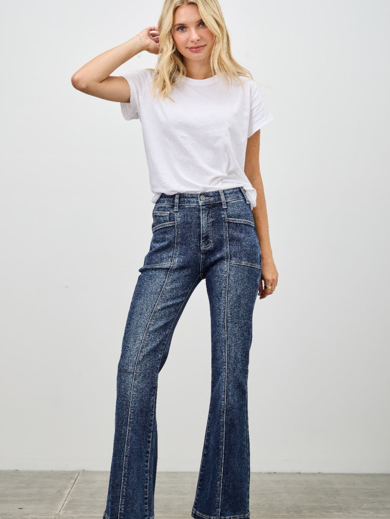 Model wearing High Rise Boot Cut With Seam Detail jeans paired with a white t-shirt against a neutral background.