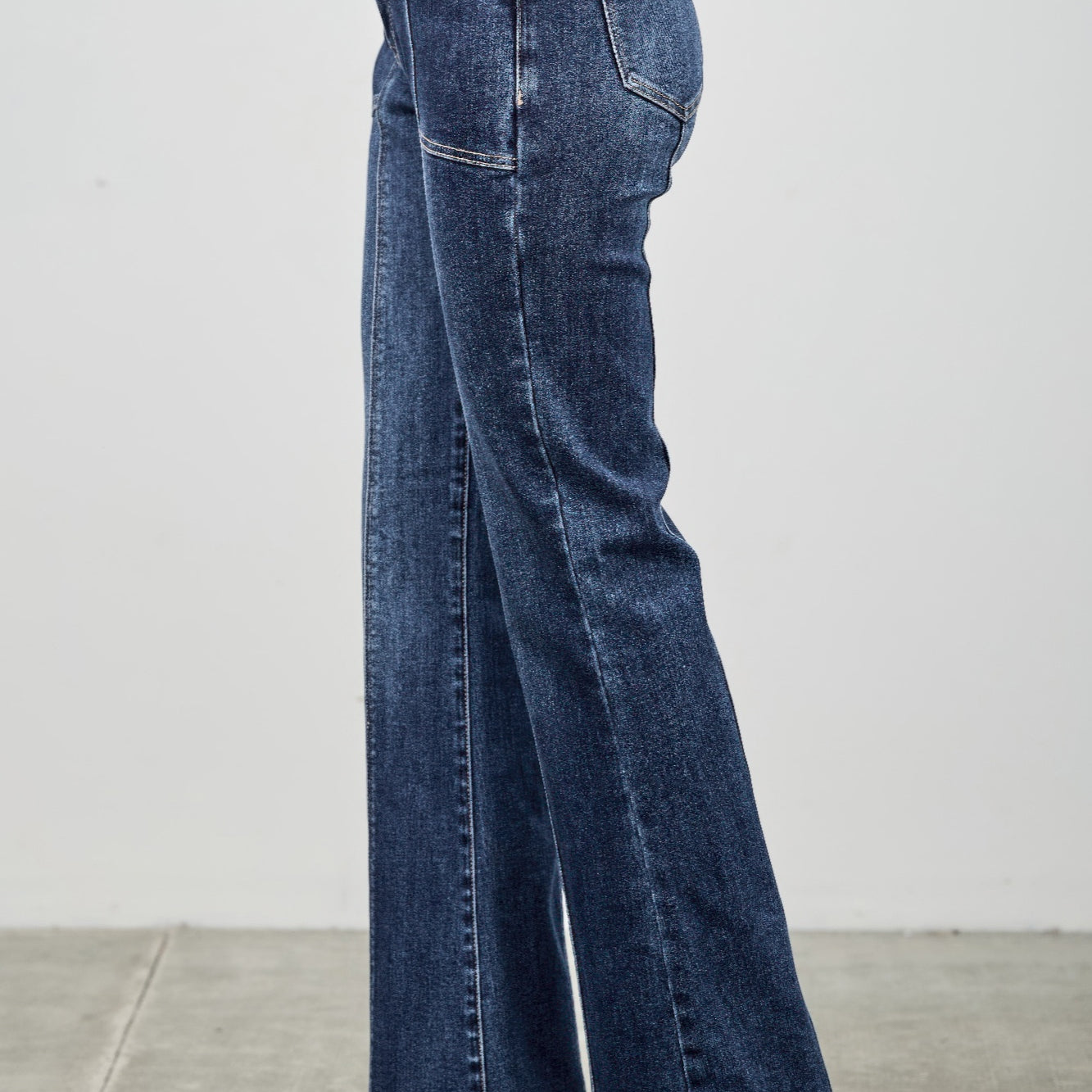 High Rise Boot Cut With Seam Detail jeans featuring a modern silhouette and flared hem, styled with sleek heels.