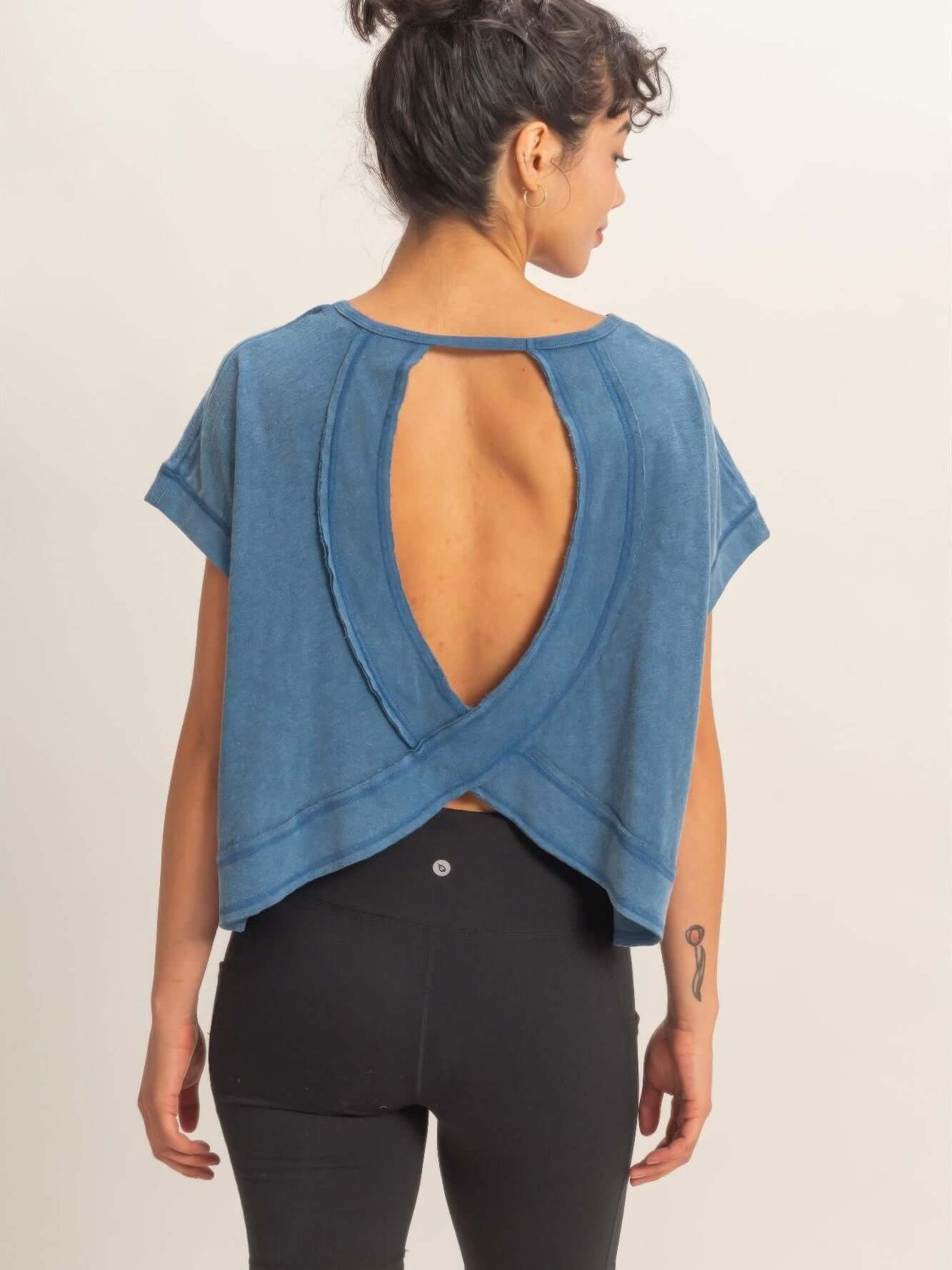 Model showcasing the Acid Washed Cross Detail Open Back Top with a modern silhouette and open back design.