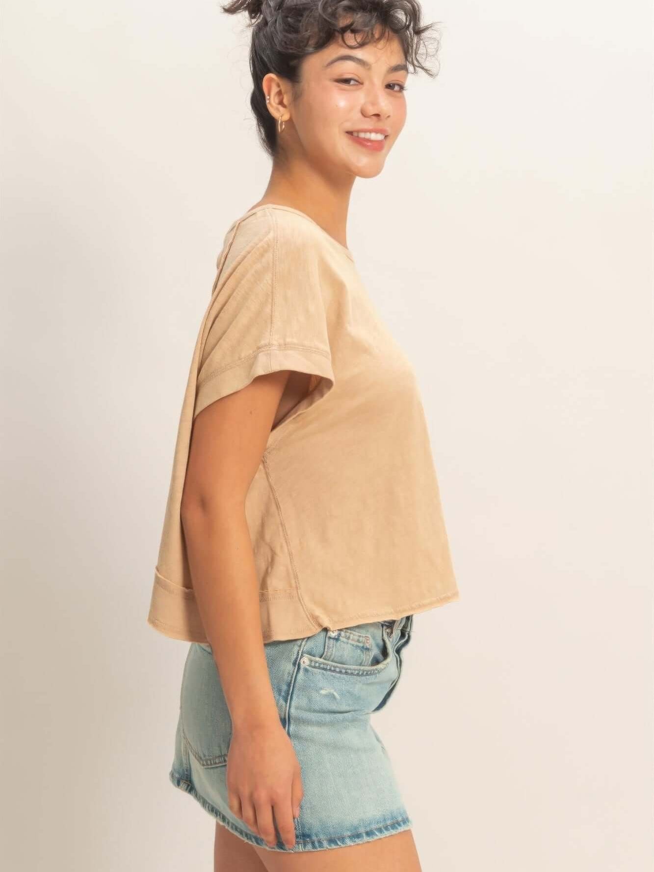 Model wearing Acid Washed Cross Detail Open Back Top, showing side view and sleek modern style.