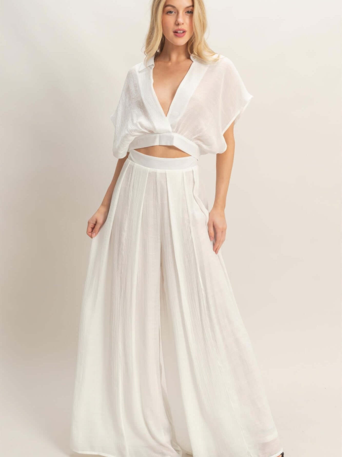 Model wearing Collared Wrap Top & Wide-leg Pants Set in white, showcasing effortless sophistication and stylish comfort.