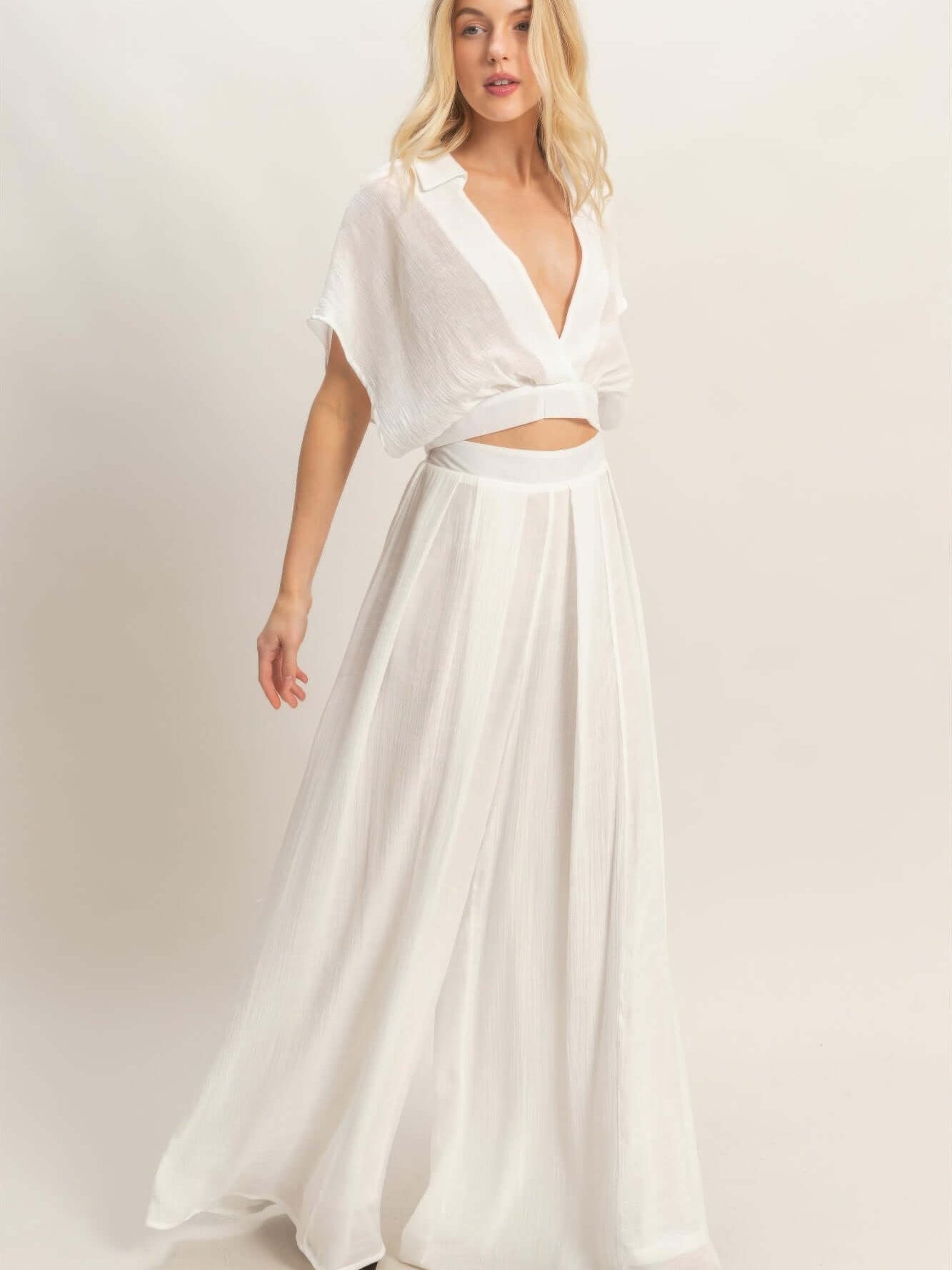 Collared Wrap Top & Wide-leg Pants Set modeled by a woman, showcasing a chic white outfit with a structured collar and flowing pants.
