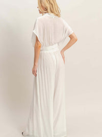 Woman wearing a Collared Wrap Top & Wide-leg Pants Set in white, showcasing the back view and flowing silhouette.