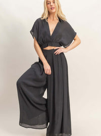 Collared Wrap Top & Wide-leg Pants Set showcasing a stylish model wearing a black cropped top and flowing wide-leg pants.