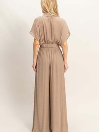 Back view of a woman wearing a Collared Wrap Top & Wide-leg Pants Set in a soft, neutral tone.