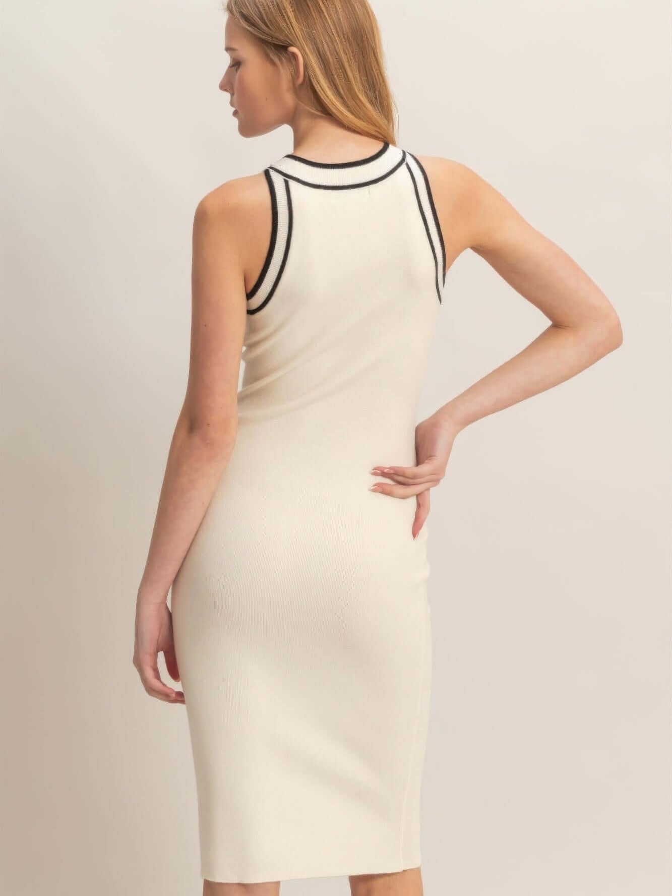 Ribbed Sleeveless Dress showcasing back view with clean lines and ribbed texture in a soft ivory color.
