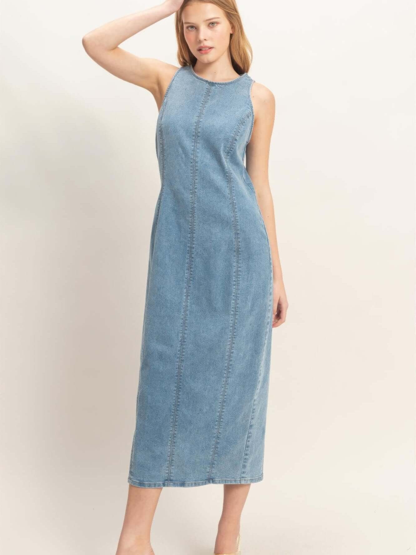 Sleeveless Denim Midi Dress worn by a model, featuring a modern design and comfortable fit.