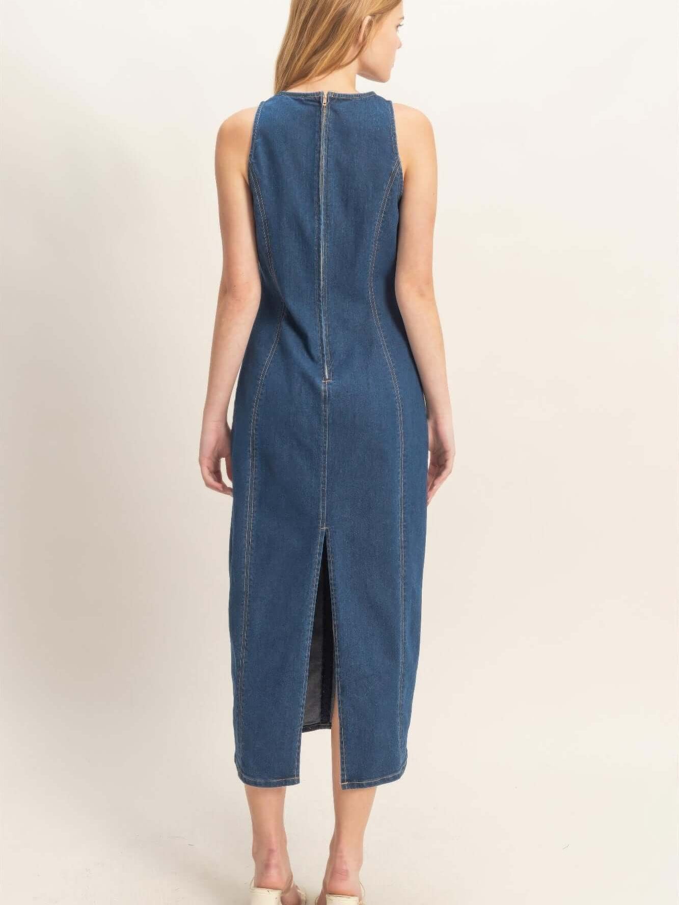 Back view of a stylish sleeveless denim midi dress featuring a straight cut and a subtle split.