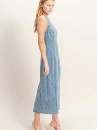Sleeveless Denim Midi Dress worn by model, showcasing the side view of modern and versatile design.
