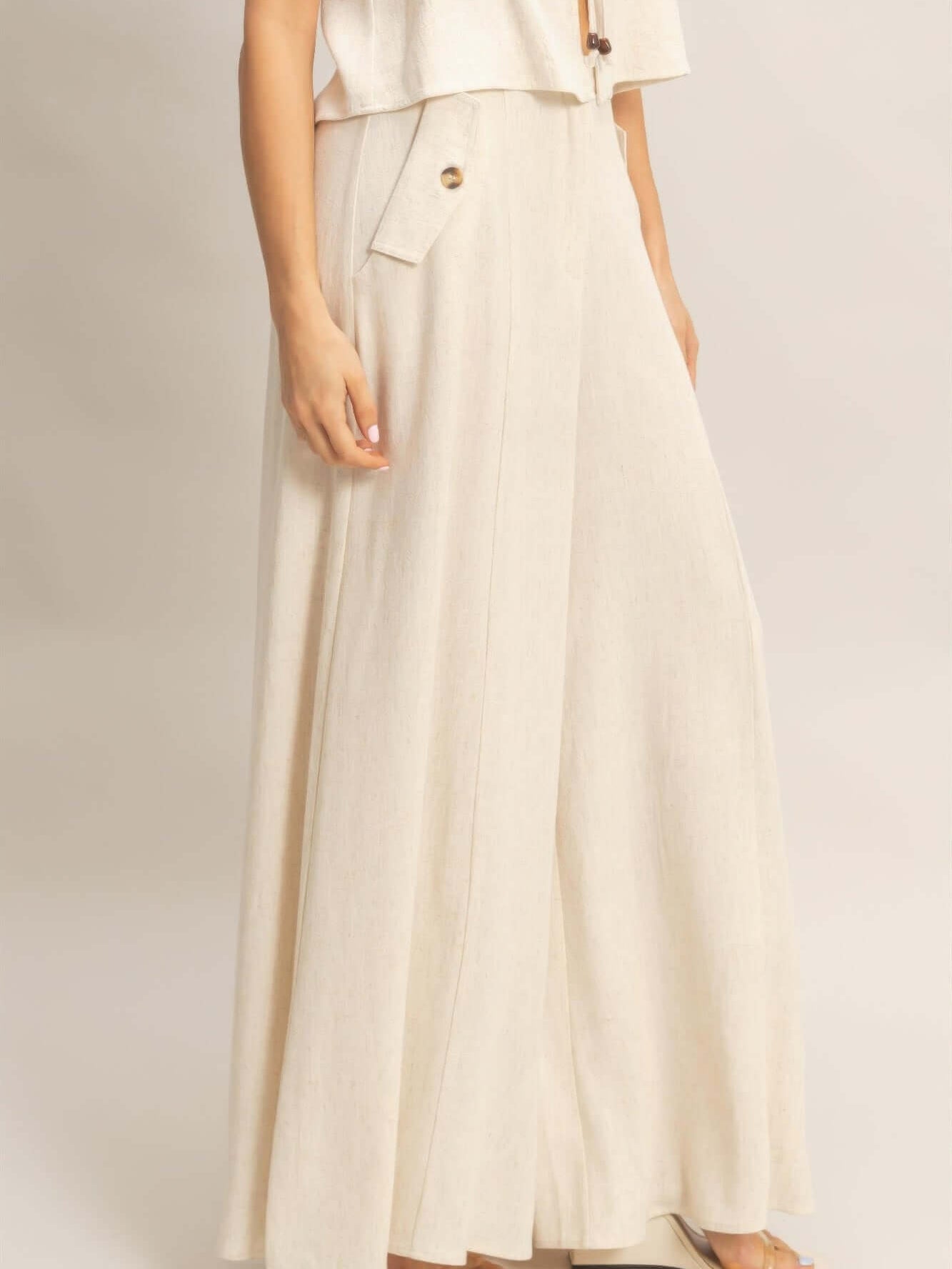 Wide-leg Flap Pocket Pants showcasing a lightweight rayon-linen blend fabric with a flowing silhouette and flap pockets.