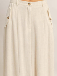 Wide-leg Flap Pocket Pants showcasing flap pockets and button closure detail on a lightweight fabric.