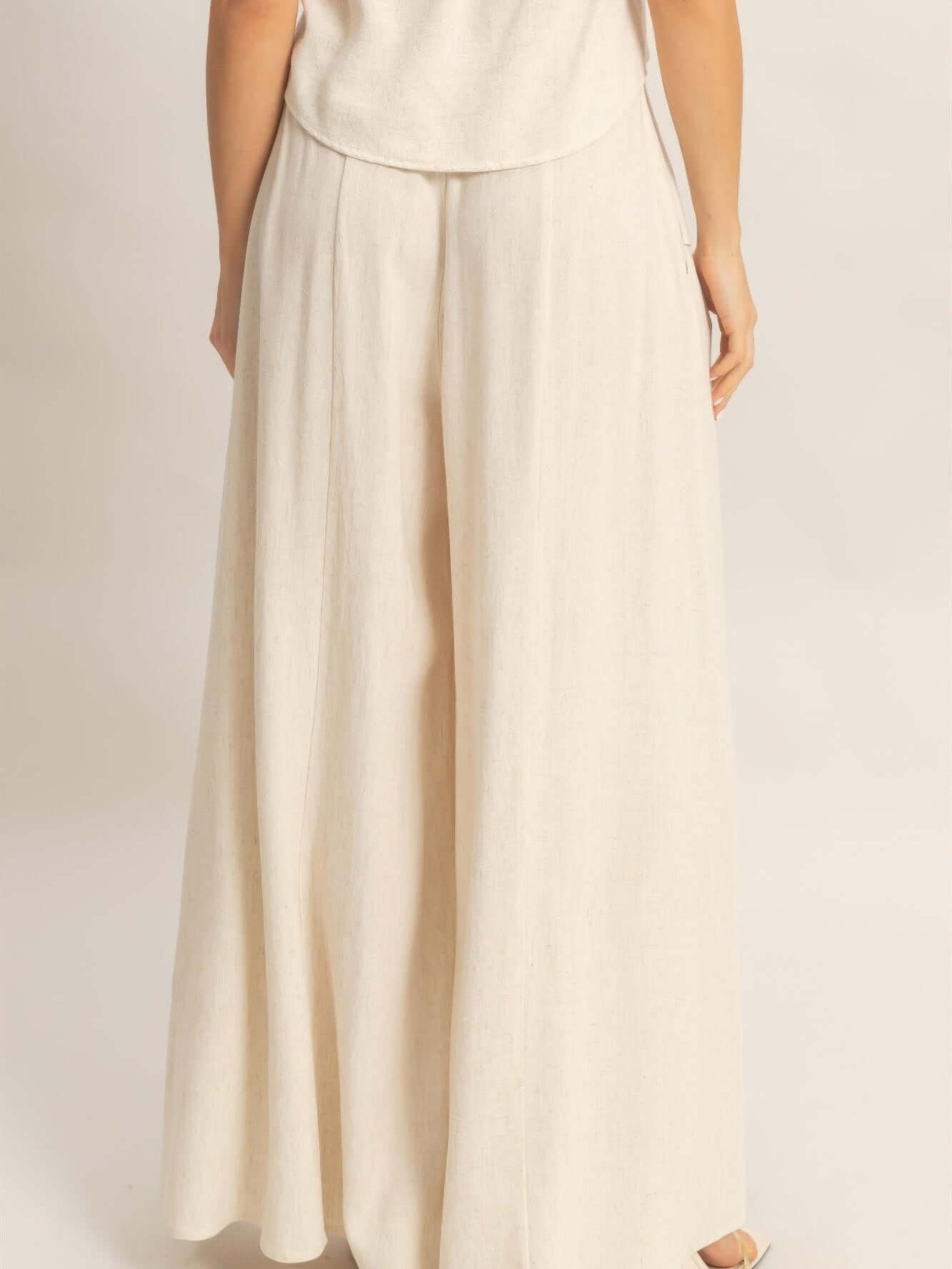 Back view of Wide-leg Flap Pocket Pants showcasing their elegant, flowing silhouette in a light fabric.