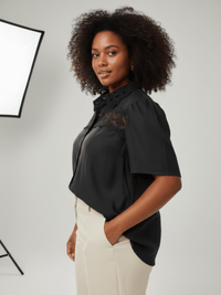 Model wearing The Inez Lace Panel Collared Blouse, a black button-front blouse with lace panel details.