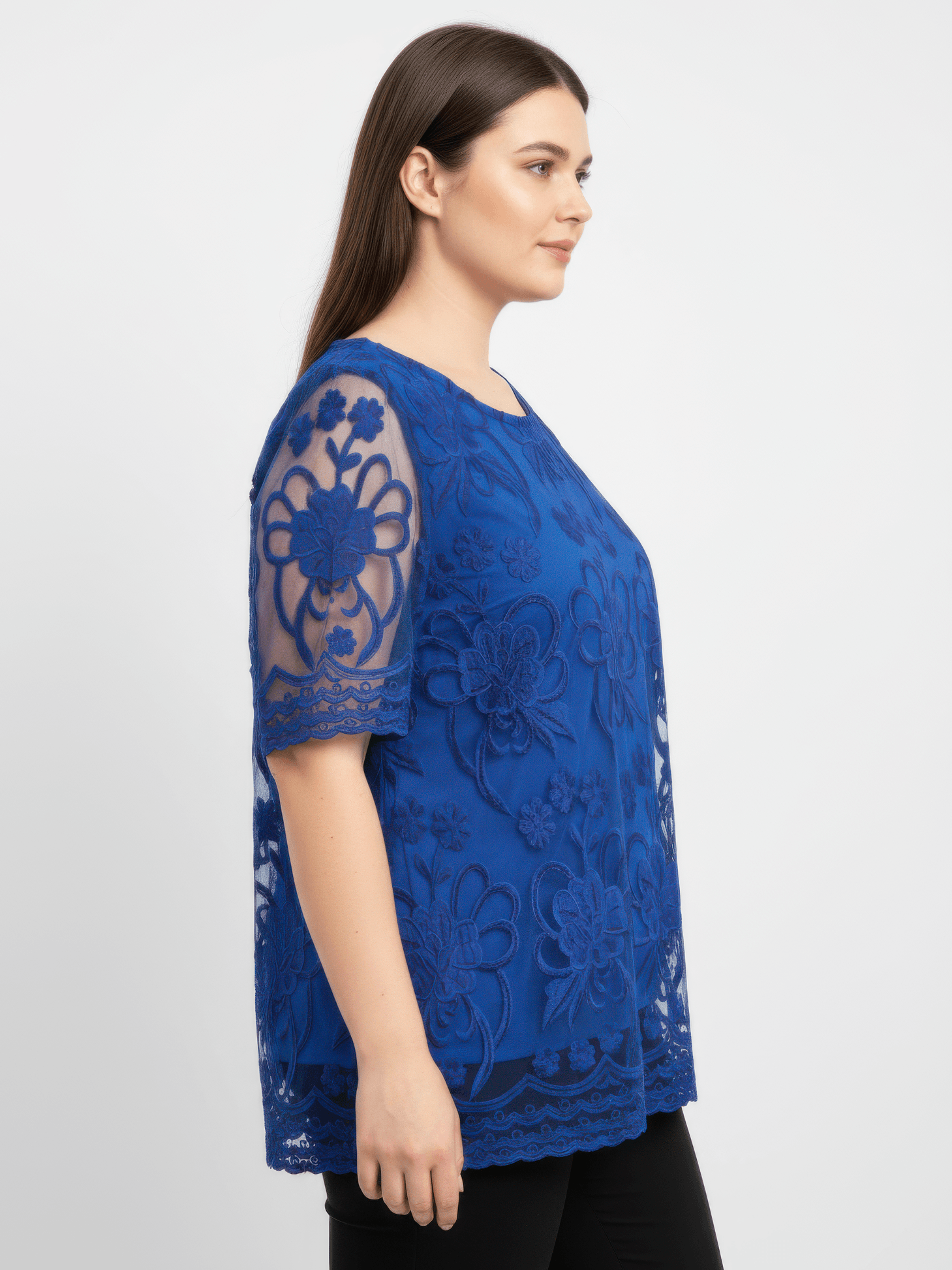The Dalia Embroidered Lace Top in blue, featuring floral lace overlay and sheer sleeves, perfect for casual or dressy occasions.