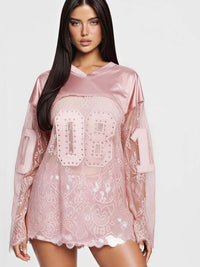 08 Long Sleeve Jersey Top with rhinestone graphic and lace detailing in a pink color for a bold athletic look.