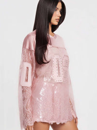 08 Long Sleeve Jersey Top featuring rhinestone graphic and lace detailing for sporty elegance.